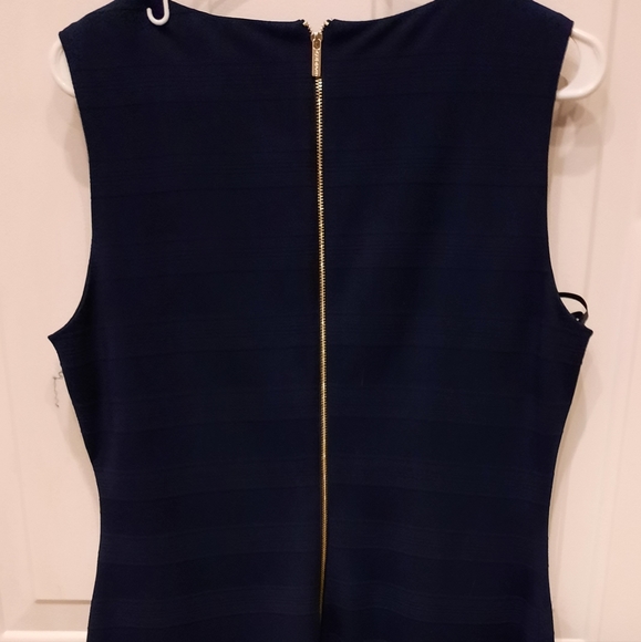 Navy blue dress, there's a pull in the material that can be tucked into fabric. - Picture 3 of 5